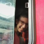 Un jeune souriant dans le camion de pompiers