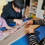 Un jeune et un parrain autour d'une table construisent un avion